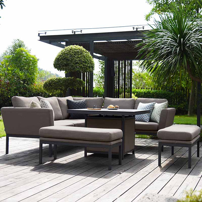 Maze Pulse Square Corner Dining Set with Fire Pit in taupe, featuring a sleek and modern design, set on a wooden deck surrounded by lush greenery for a perfect outdoor living experience.