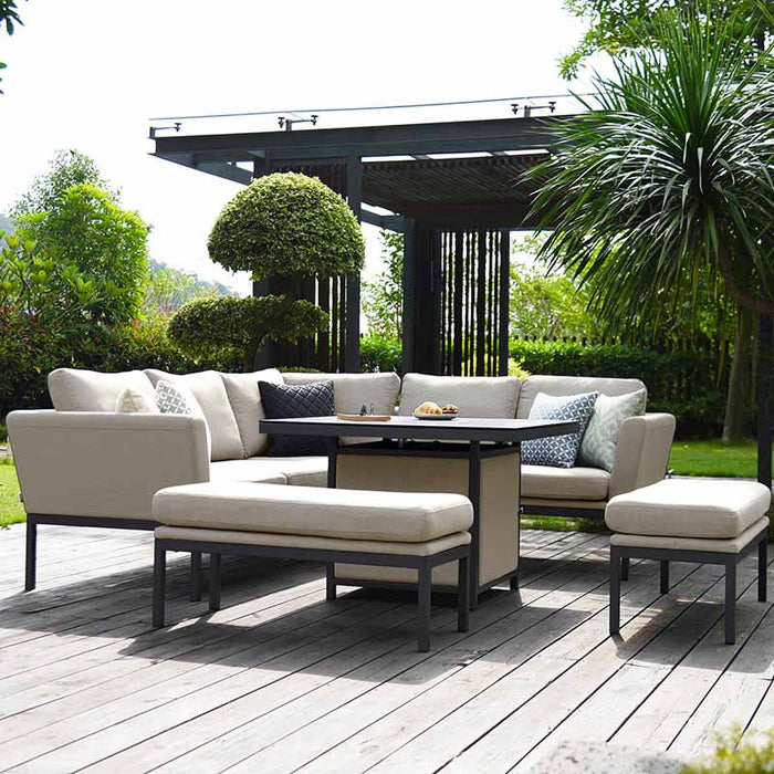 A modern Pulse Square Corner Dining Set with soft oatmeal cushions, featuring a stylish fire pit table, set in a garden for cosy outdoor dining and relaxation.