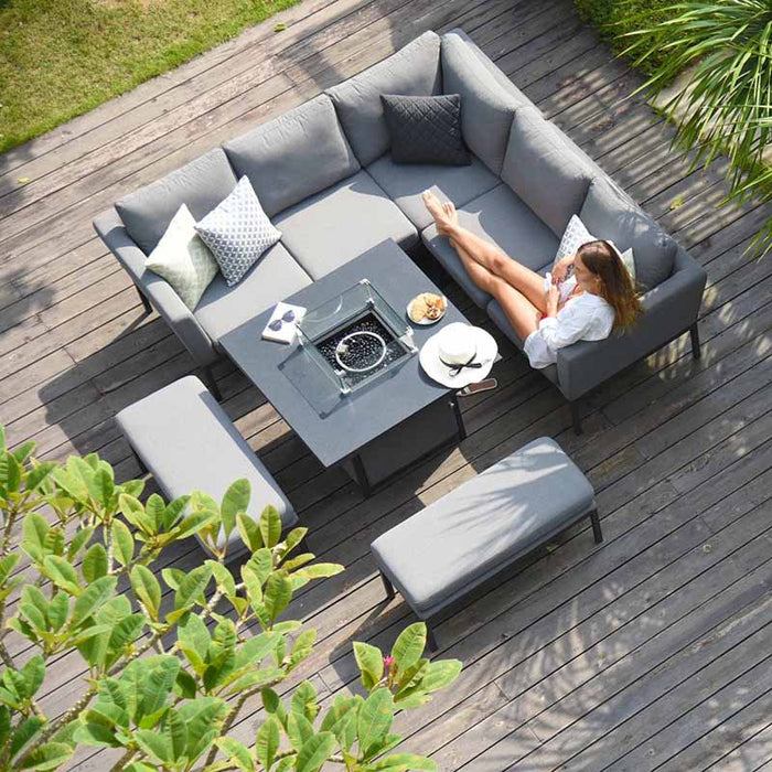 A beautifully styled lifestyle shot of the Pulse Square Corner Dining Set with Fire Pit, featuring Flanelle cushions in a serene outdoor setting.