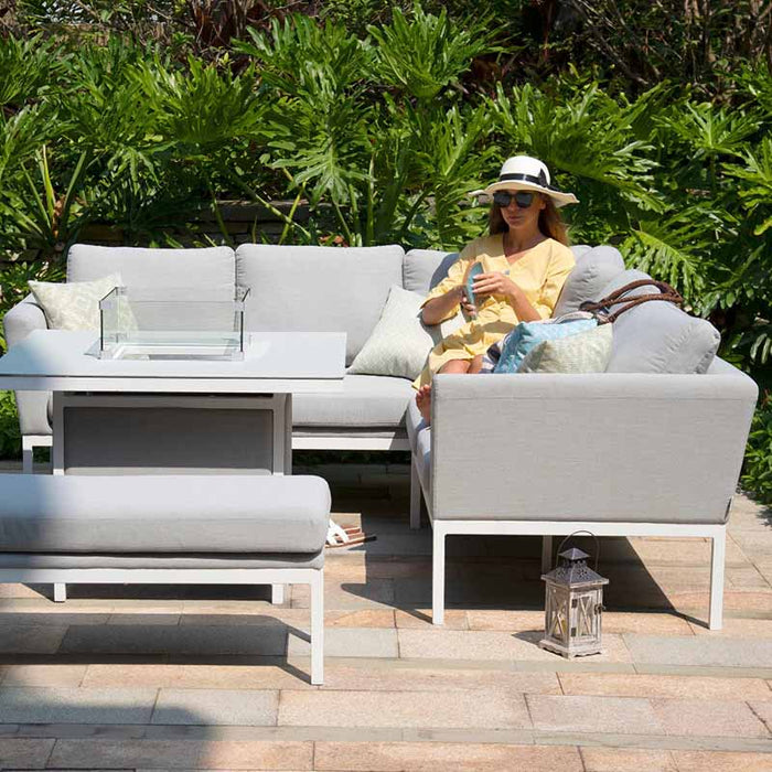 A lifestyle view of the Pulse Square Corner Dining Set, featuring lead chine cushions and a fire pit table, perfect for outdoor relaxation.