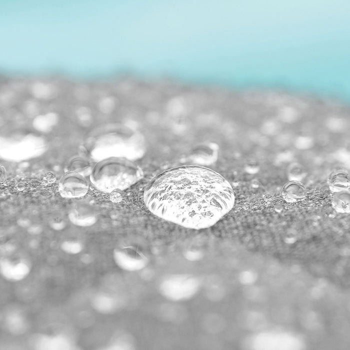 A close-up of water droplets on the lead chine cushion, showcasing the water-resistant fabric of the Pulse Square Corner Dining Set.