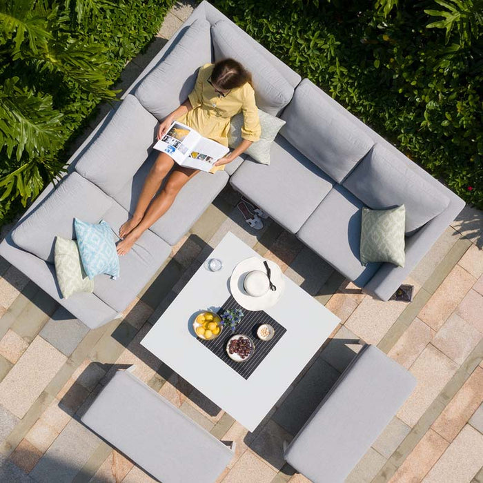 Angled bird's-eye view of Pulse Square Corner Dining Set in lead chine, showing comfortable seating arrangement and rising table with refreshments.