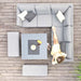 Bird's-eye view of woman seated on the Pulse Square Corner Dining Set with Rising Table in flanelle, table set with refreshments.