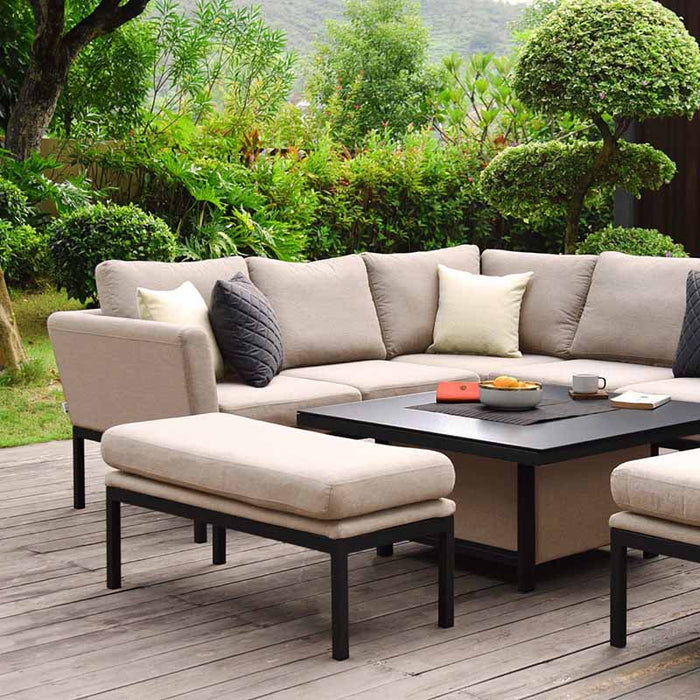 Pulse Square Corner Dining Set with Rising Table in taupe, set in a lush garden. Featuring comfortable taupe cushions on the corner sofa and benches, paired with a sleek, adjustable square table for outdoor dining and lounging.