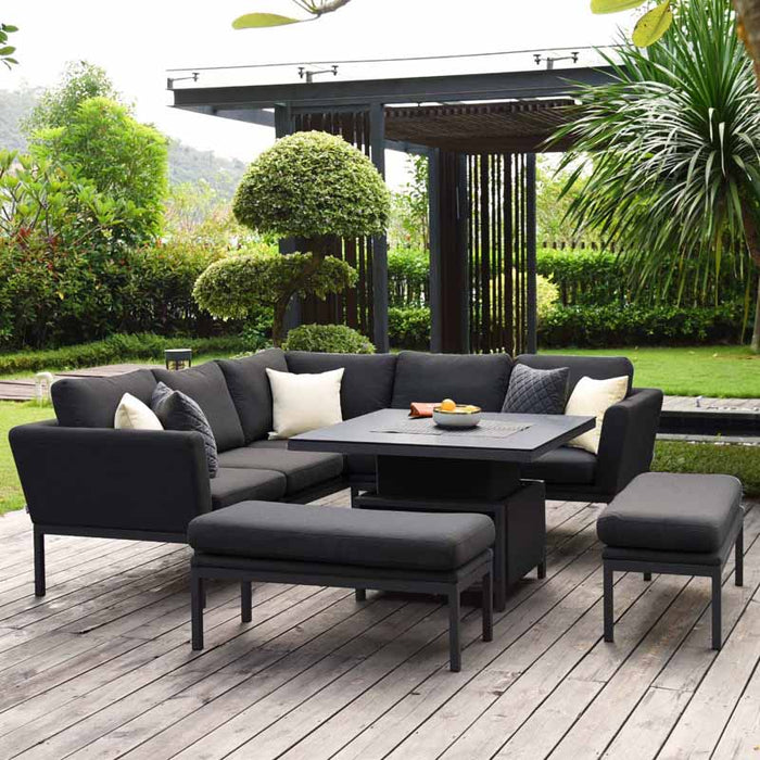 Full shot of Pulse Square Corner Dining Set with Rising Table in a garden setting, featuring a charcoal finish.