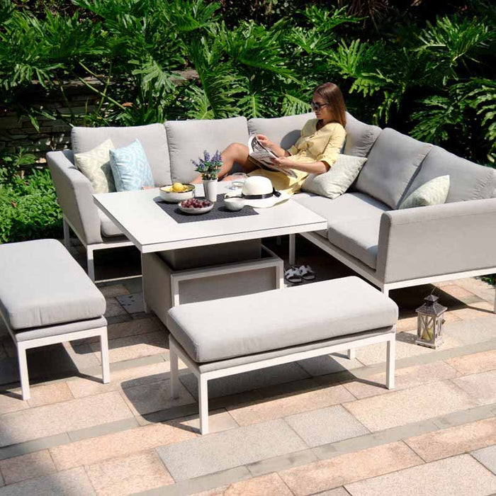 Low side-angle shot of the Pulse Square Corner Dining Set with Rising Table, highlighting cushion and table details in lead chine.