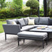 Pulse Square Corner Dining Set with Rising Table in flanelle, displayed in a patio outdoor setting with trees and cushions.