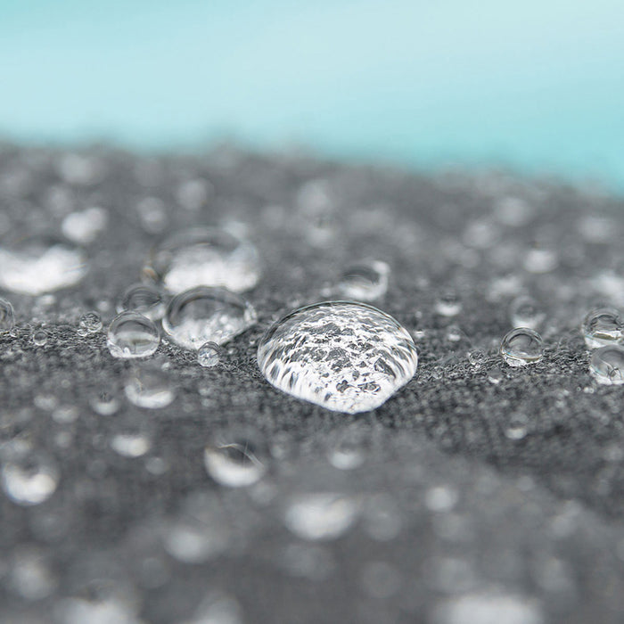 Close-up of water drops on the flanelle fabric of the Pulse Square Corner Dining Set, highlighting water-repellent material.