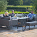 Group of people seated on the Pulse U Shape Corner Dining Set with Fire Pit, creating a cosy and inviting outdoor atmosphere.