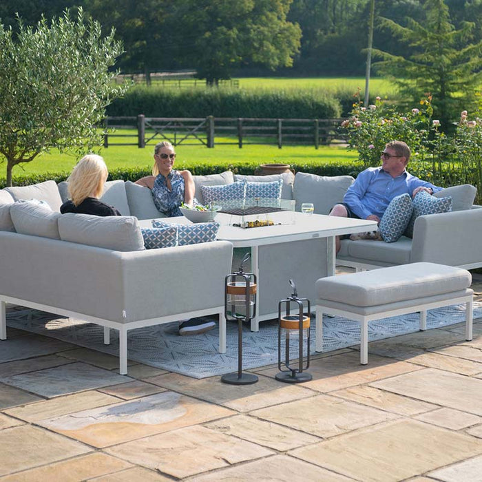 Group relaxing on the Pulse U Shape Corner Dining Set with Fire Pit in lead chine, designed for comfortable outdoor lounging.