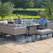 A group of people relaxing on the Pulse U Shape Corner Dining Set in taupe, with a central fire pit, offering a cosy and elegant outdoor seating space.