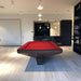 Contemporary MBM Biliardi B_ig Pool Table with dark wood frame and striking red felt, situated under pendant lighting in a modern residential games room.