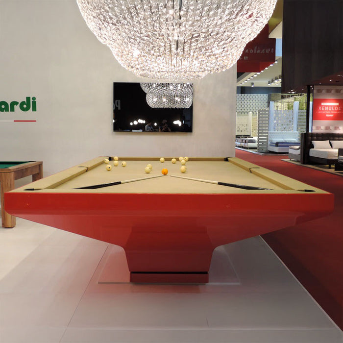 Luxurious red MBM Biliardi B_ig Pool Table with golden beige felt and modern crystal chandelier above in showroom setting.