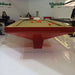 MBM Biliardi B_ig Pool Table in bold red gloss finish with light tan felt, showcased in a premium exhibition environment.