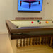 MBM Biliardi Kyoto contemporary billiard table with cue rack and balls displayed at trade fair.