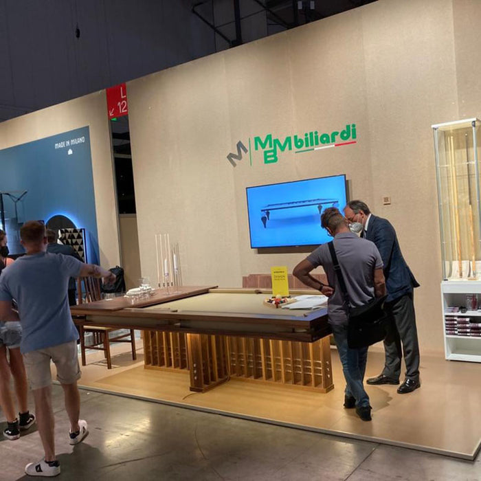 Visitors viewing MBM Biliardi Kyoto designer pool table at international furniture exhibition.