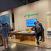 Visitors viewing MBM Biliardi Kyoto designer pool table at international furniture exhibition.