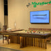 Side view of MBM Biliardi Kyoto luxury pool table set for dining at premium design fair.