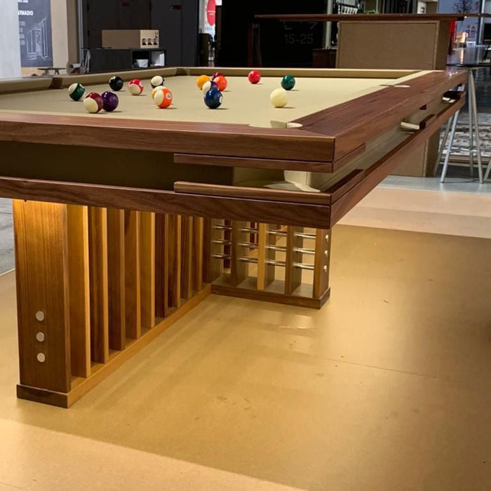 Close-up of MBM Biliardi Kyoto modern billiard table with LED-lit wooden base and balls in play.