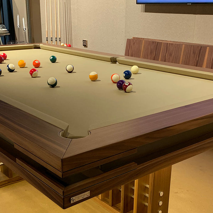 MBM Biliardi Kyoto premium billiard table with balls in play on beige cloth surface.