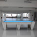 MBM Biliardi Quantum pool table with light oak finish and electric blue felt, placed in a minimalist industrial-style space with panoramic views.