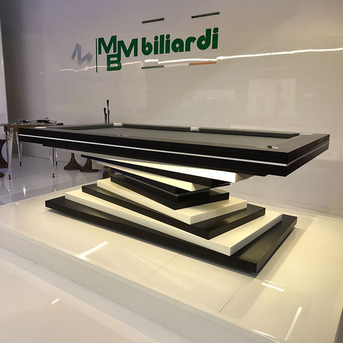 A modern MBM Biliardi Ziggurat pool table with a dark wood frame and cream-colored felt, displayed in a showroom setting.