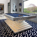 A luxurious MBM Biliardi Ziggurat pool table with red felt, white frame, and a blue accent on the layered base, in an elegant home interior.