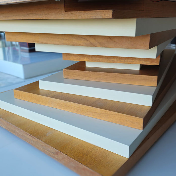 A close-up view of the MBM Biliardi Ziggurat pool table's base, showing the intricate layers of alternating wood grain and white finishes.