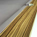 Close-up of an MBM Biliardi Ziggurat pool table pocket with pool balls near the edge, showing the wood, cream leather, and lilac felt.