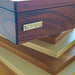 Close-up of the MBM Biliardi logo on a rich wood Ziggurat pool table, showcasing the luxurious design and craftsmanship.