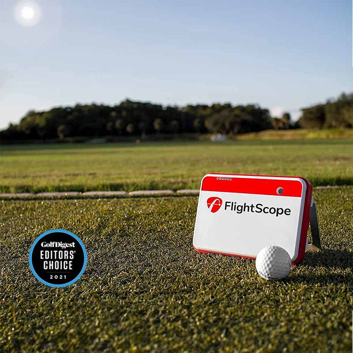 FlightScope Mevo+ monitor on grass with Editor's Choice seal beside it.