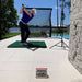 Mevo+ used by golfer with mat at an outdoor terrace with pool.