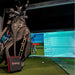 FlightScope Mevo+ monitor beside golf bag with simulation screen in the background.