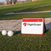 FlightScope Mevo+ on a driving range with golf balls.