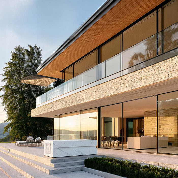 Marble-finish LOKI Ice Bath by Nordic Vitality on a sunlit terrace overlooking a calm lake, paired with Scandinavian architecture and minimalist outdoor furnishings.