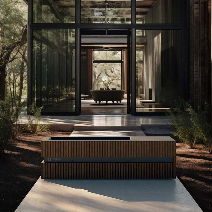 Stylish wood-accented Nordic Vitality LOKI Ice Bath placed in front of a glass-fronted architectural retreat, merging natural wellness with modern design.