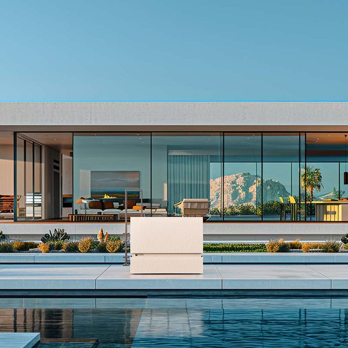 Nordic Vitality THOR Ice Bath in Ardesia Bianco finish on a sunlit pool deck of a modern villa with mountain views and full glass façade.