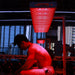 Athlete undergoing red light therapy session under the Nuvibody CORE 1500 QUAD device in a modern gym, enhancing muscle recovery, strength, and performance.