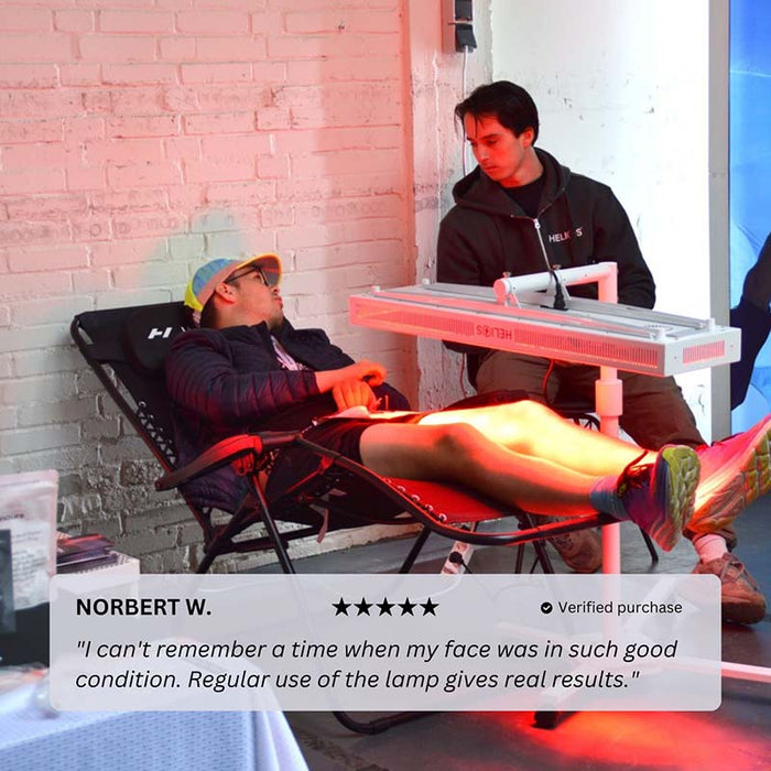 Man receiving red light therapy session with Nuvibody CORE 1500 QUAD device while reclining, guided by a specialist in a wellness setting for optimal skin health and recovery results.