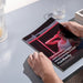 Close-up of Nuvibody CORE 1500 QUAD Red Light Therapy Device user manual featuring a woman enjoying red light treatment, showcasing multilingual instructions and premium design.