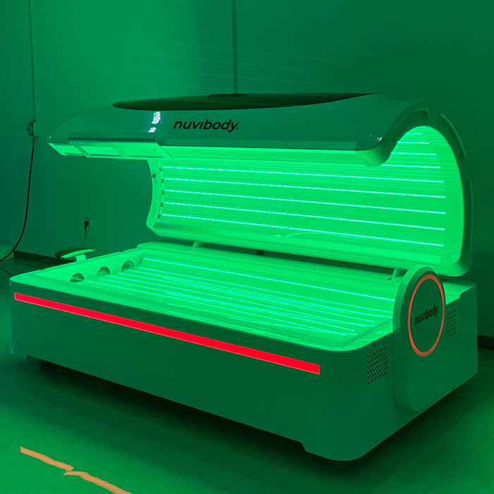 Nuvibody PRO therapy bed activated in green light therapy mode, offering a visual of the LED panel functionality and wellness versatility.