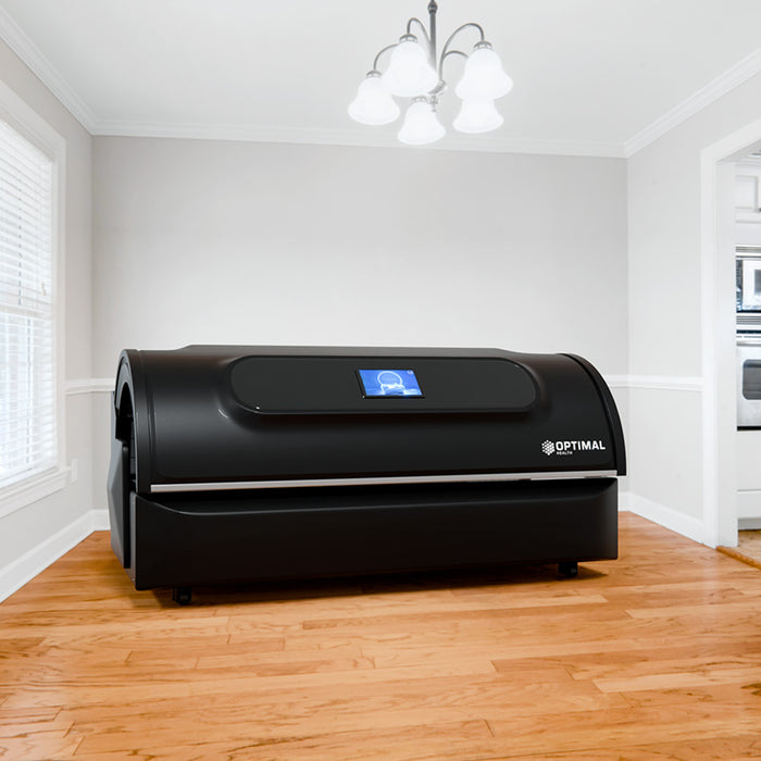 A sleek red light therapy bed installed in a modern home setting, offering professional-grade full-body light therapy.