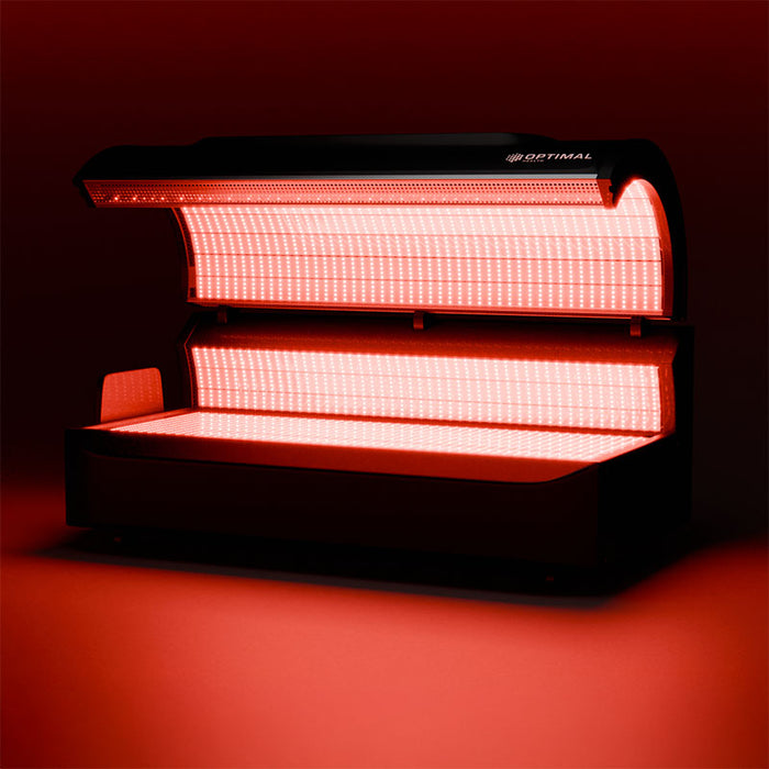 The red light therapy bed glowing in full activation mode, delivering targeted near-infrared and red light wavelengths.