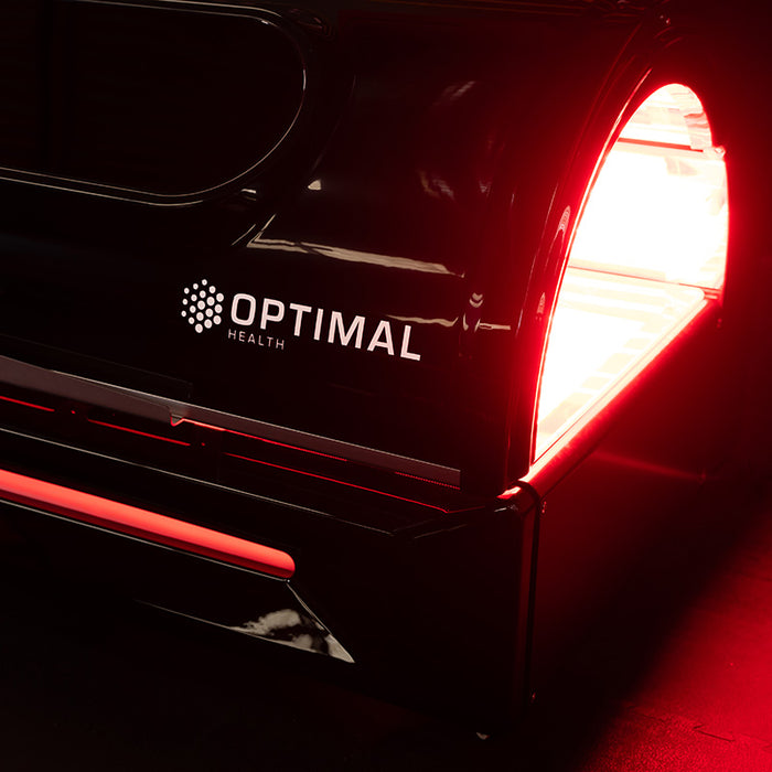 Side angle of the Optimal Health Red Light Therapy Bed, showcasing its modern design and Optimal Health branding.