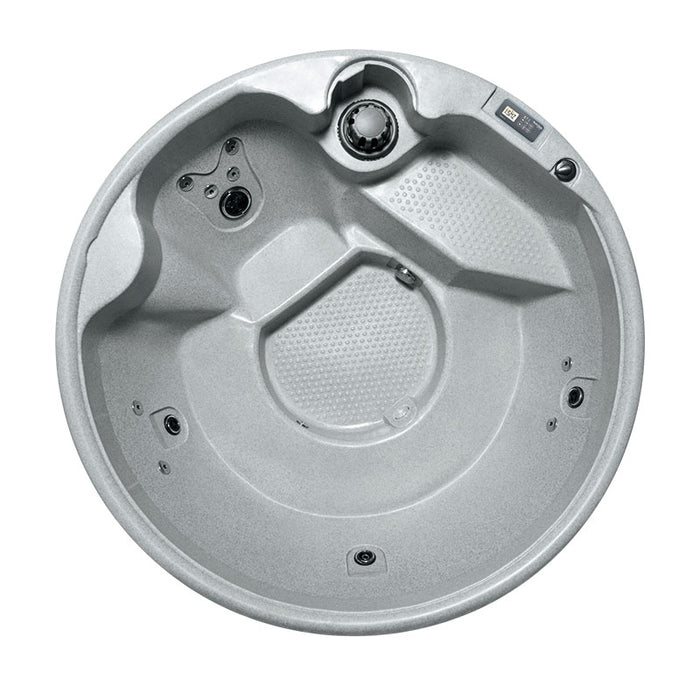  Top-down view of a round hot tub with a light grey textured interior.