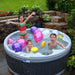 Children playing with colorful balloons in an outdoor hot tub.