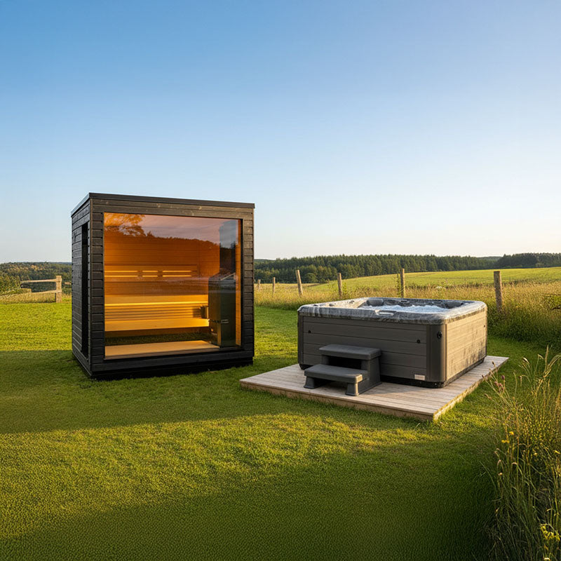 Modern outdoor wellness setup with a Saunum glass-front sauna and a Wellis hot tub on a wooden deck, set against a scenic countryside backdrop.