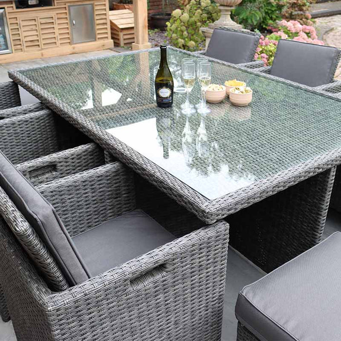 The Paris 10 Seater Cube Set highlighting the spacious glass-topped table, perfect for outdoor dining, with a stylish grey rattan finish.