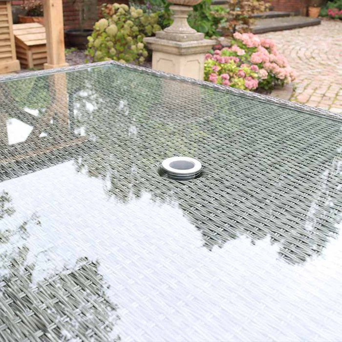 The Paris 10 Seater Cube Set’s glass tabletop, featuring an umbrella hole, ideal for adding shade during garden gatherings.