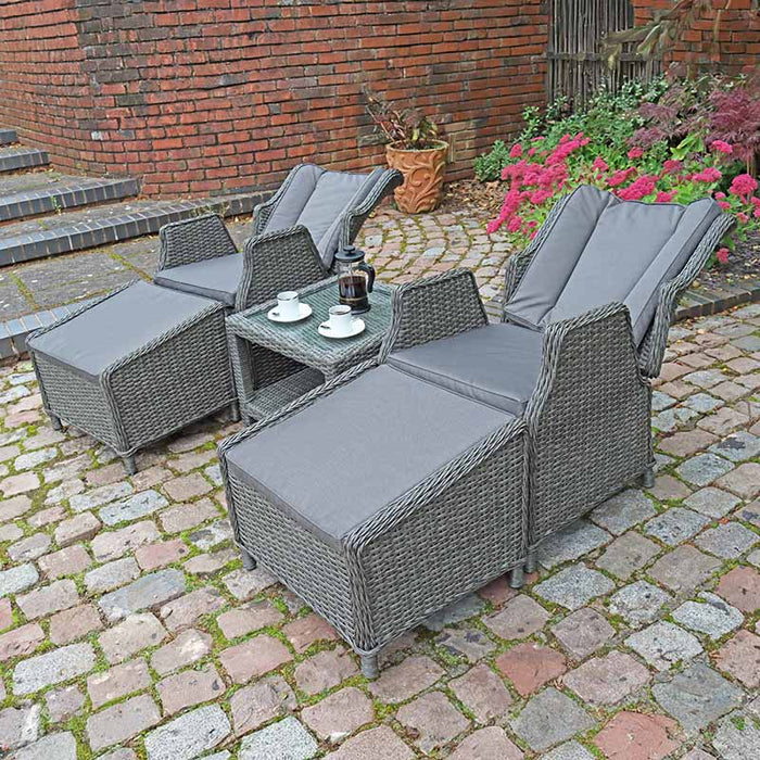 The Paris 2 Seater Recliner Set, including footstools, is shown in a peaceful garden, showcasing its stylish and comfortable design.